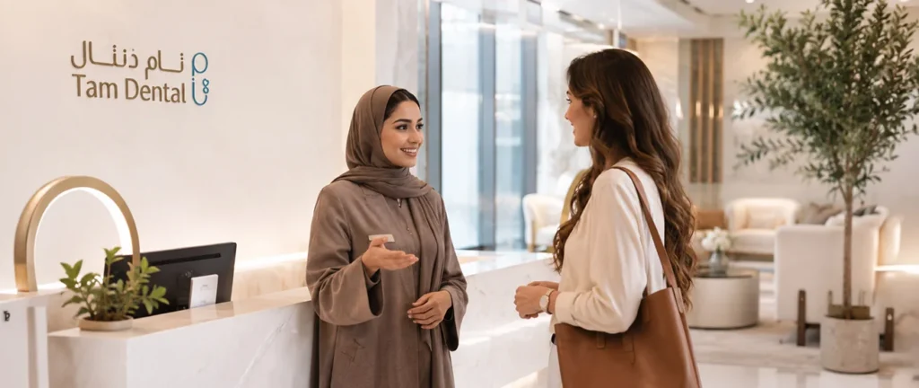 Patient chatting with a team member at the Tam Dental clinic reception in Jeddah