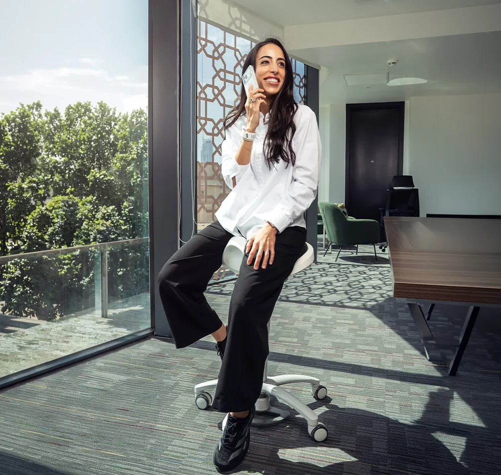 Dr. Dina Husein, endodontist at Tam Dental, taking a call in the office in Jeddah