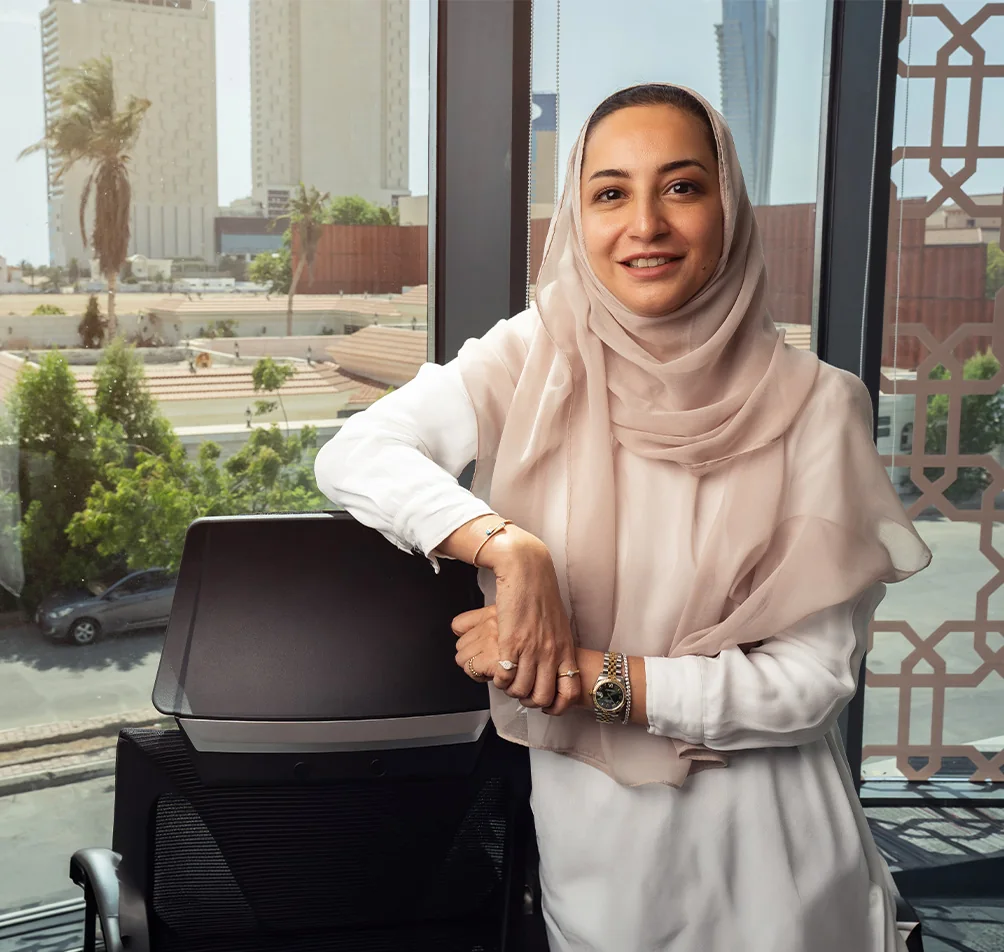 Dr. Shatha Alshali, prosthodontist at Tam Dental, standing by the office window in Jeddah