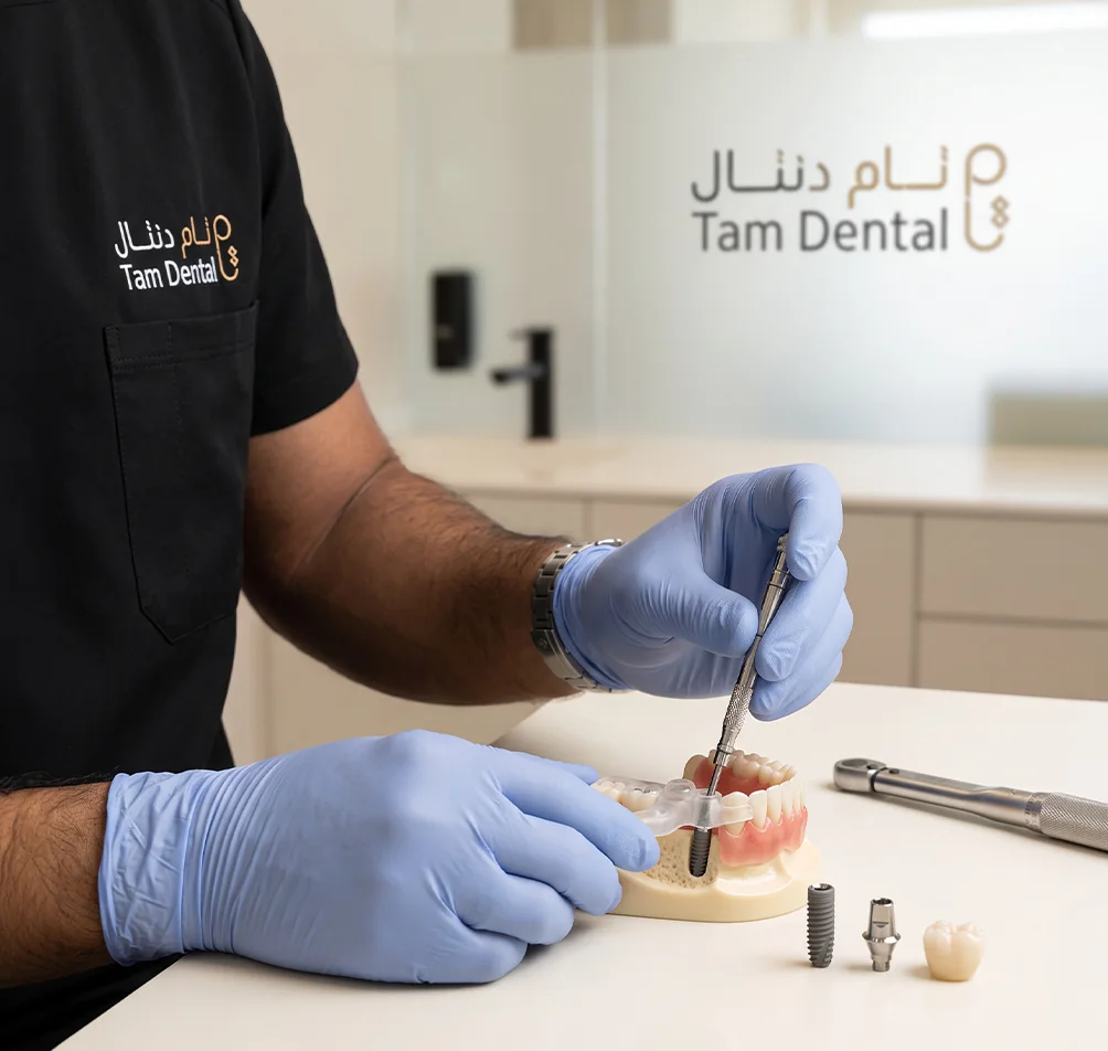 Implantologist working on a dental implant model at Tam Dental in Jeddah