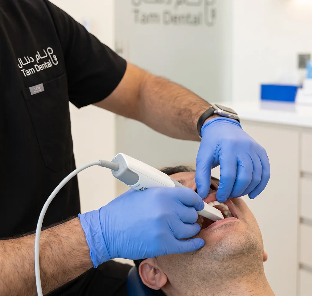 Dentist using an intraoral scanner to take a digital impression at Tam Dental in Jeddah