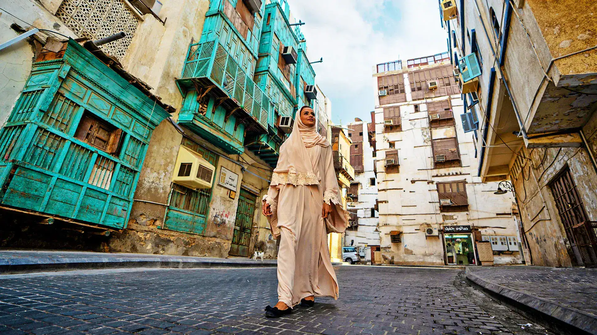 Woman walking through the historic Al-Balad old town of Jeddah, a UNESCO World Heritage site in Saudi Arabia
