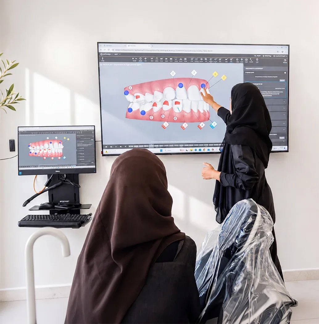 Tam Dental specialists reviewing a 3D digital smile design during treatment planning in Jeddah