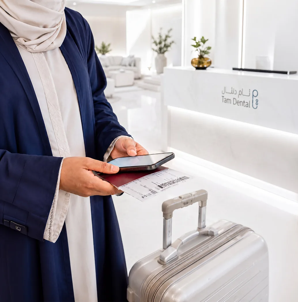 Patient arriving at the Tam Dental clinic reception desk in Jeddah