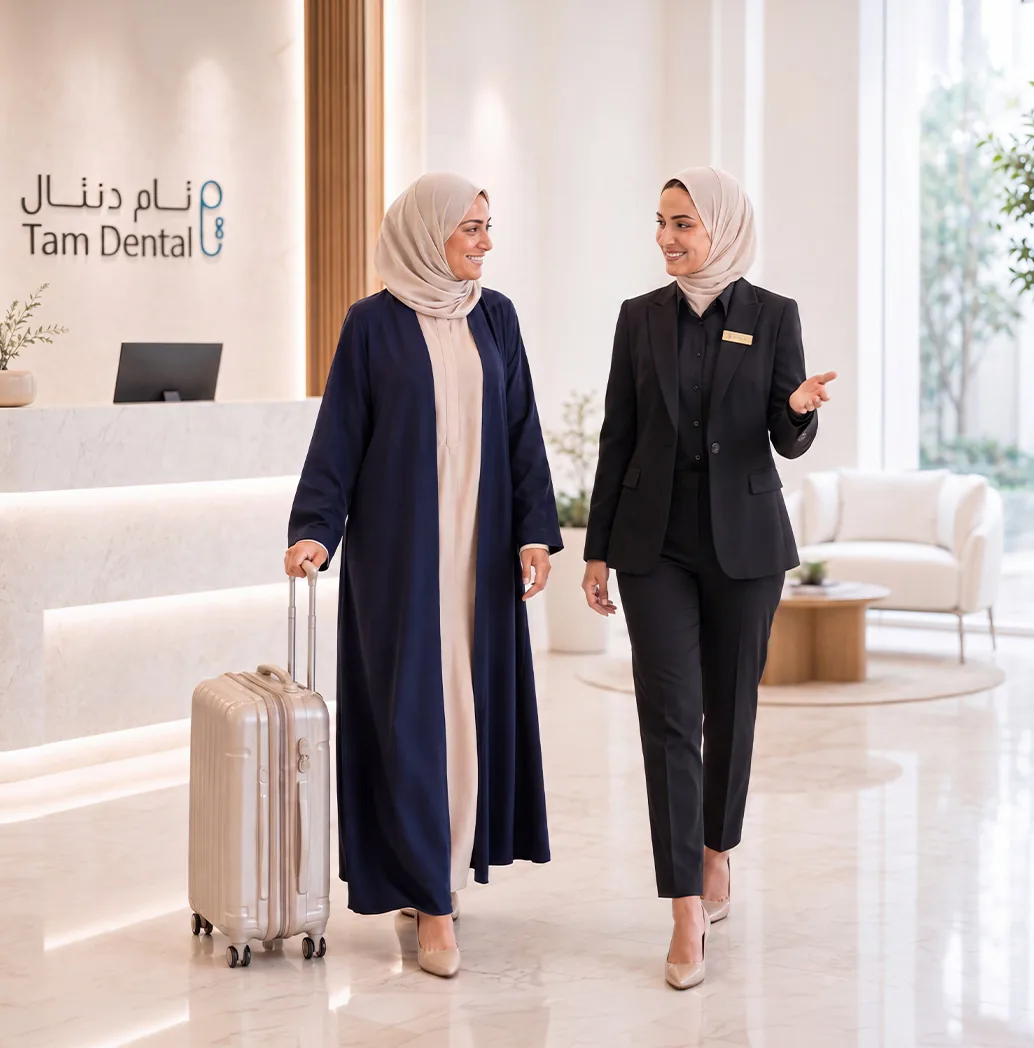 Tam Dental staff member welcoming an arriving patient in the clinic lobby in Jeddah
