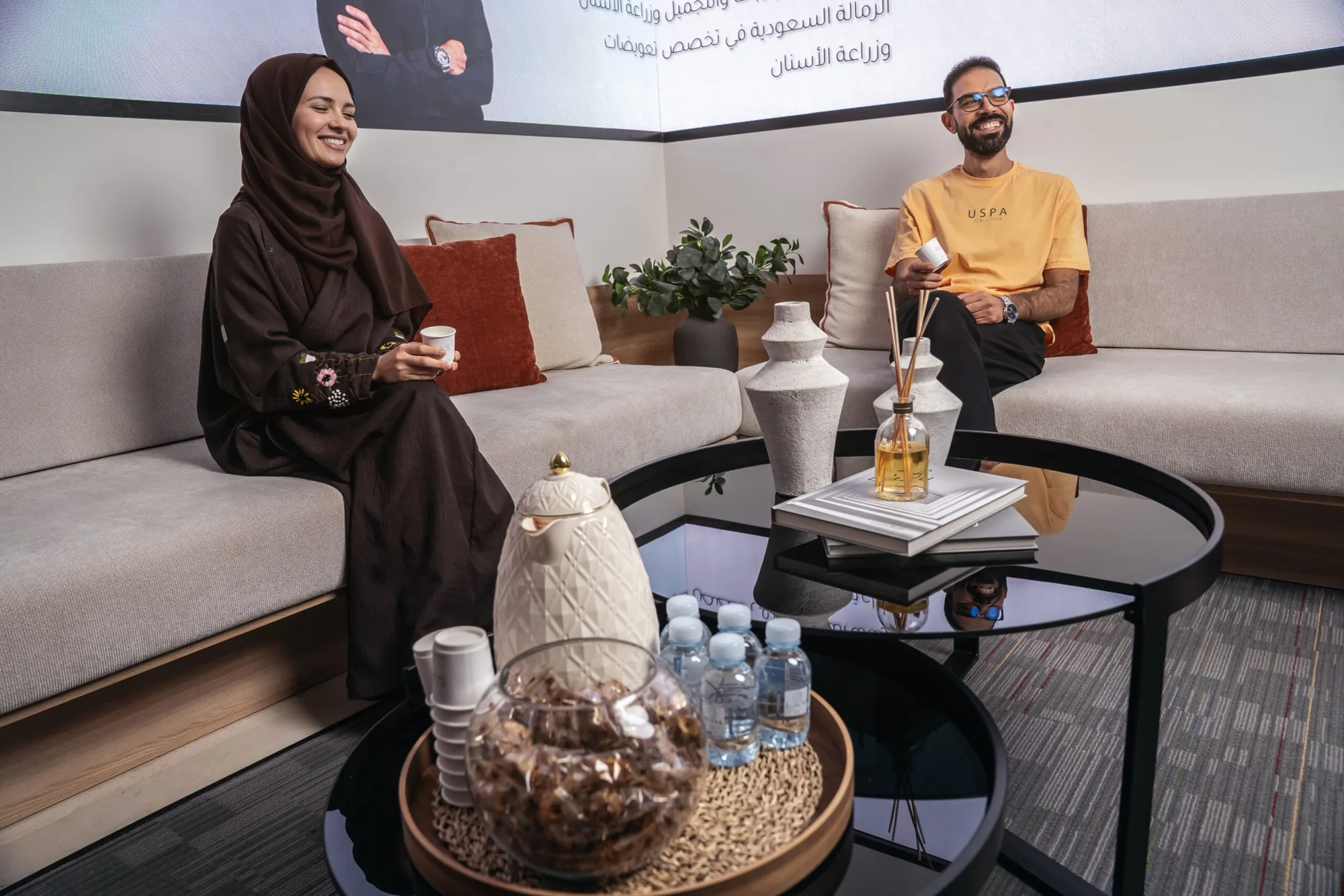 "Patients relaxing with coffee in the Tam Dental consultation lounge in Jeddah